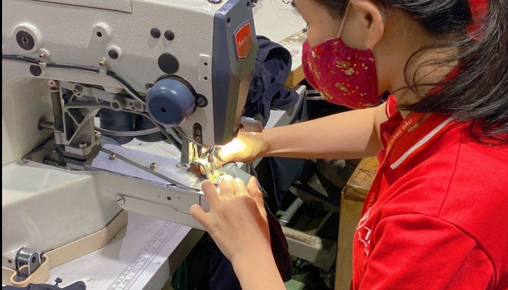 Operator using a programmable template sewing machine at TAV