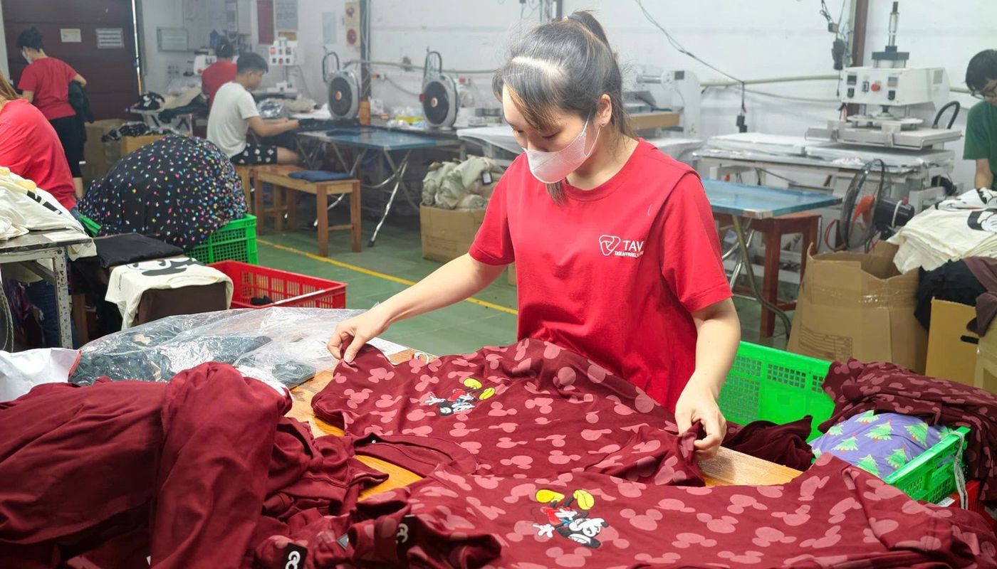 Operator preparing cut panels at a sewing line in TAV Factory 1, Bac Ninh, Vietnam